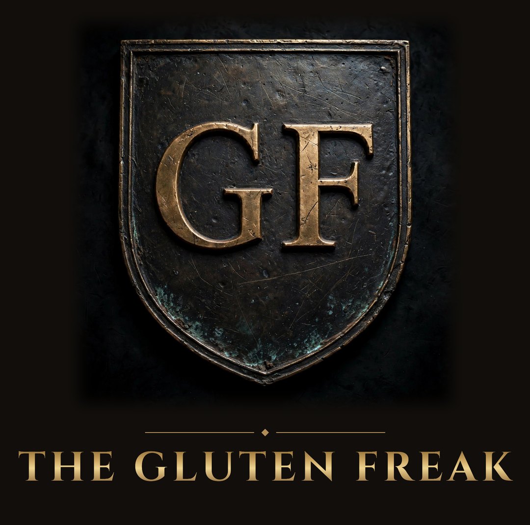 The Gluten Freak crest: GF in raised bronze Roman letters on an aged shield plaque